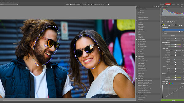 Screenshot of photo editing software showing a portrait of two people wearing sunglasses outdoors.