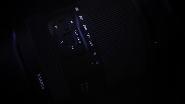 Close-up of camera lens markings and aperture settings in low light.
