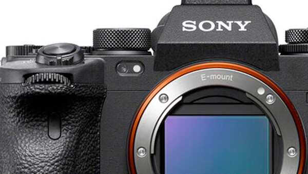 Sony E-mount mirrorless camera body shown from above with lens mount visible and orange accent ring.