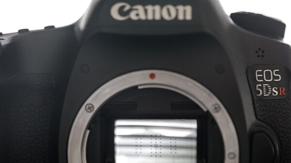 Canon EOS 5DS DSLR camera body with mirror open, showing the sensor and internal mirror mechanism.