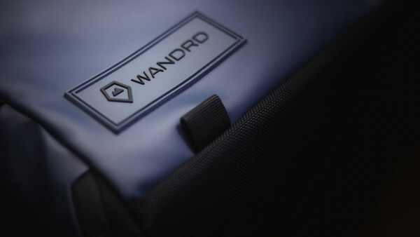 Close-up of a Wandpro branded label on camera equipment with dramatic side lighting.