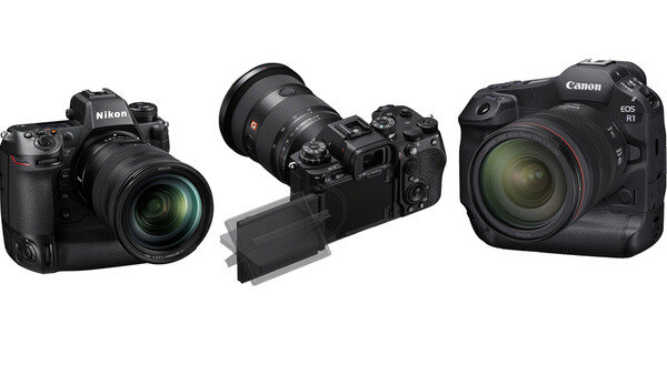 Three professional mirrorless cameras displayed side by side with attached lenses.