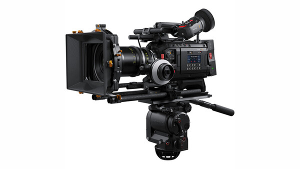 Professional cinema camera with matte box and follow focus mounted on fluid head tripod.