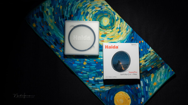 Haida camera filters and packaging displayed on a Van Gogh Starry Night-inspired fabric backdrop.