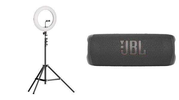 Ring light on tripod stand and portable JBL speaker displayed side by side.