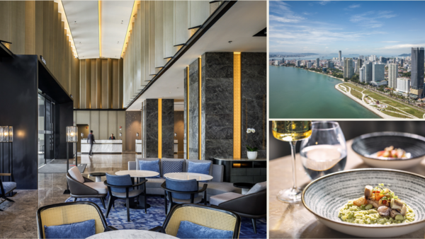 Luxury hotel lobby with modern design featuring gold ceiling details, blue seating, and marble accents.