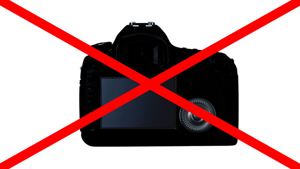 Illustration of a DSLR camera with a red X overlaid across it.