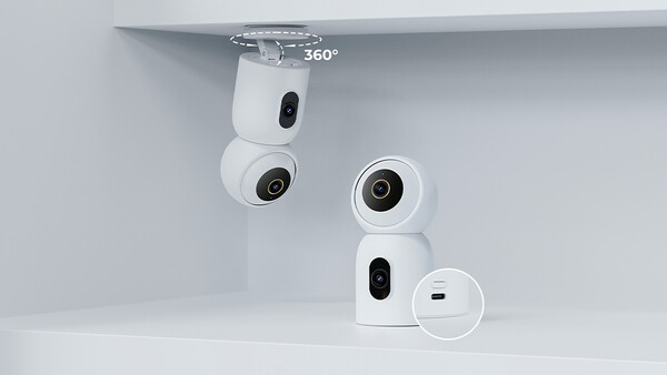 Product shot of white compact surveillance cameras mounted on white shelving, showing 360-degree rotation capability.