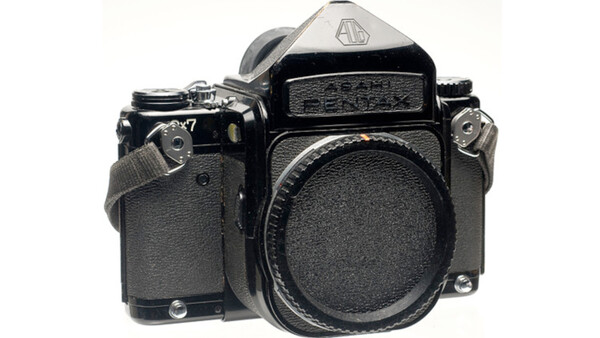 Black medium format film camera body shown from front-left angle against white background.