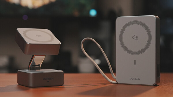 Three smartphone magnetic charging accessories arranged on a wooden surface with blurred interior background.
