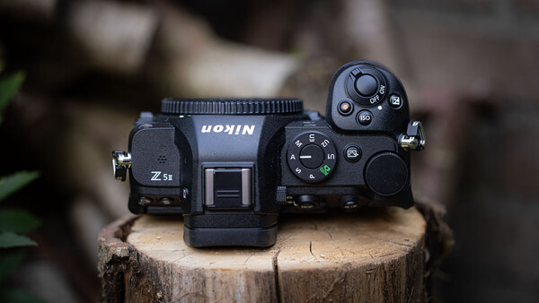 Top-down view of a Nikon Z5 mirrorless camera on a wooden surface.