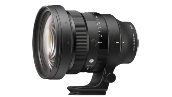 Black telephoto lens with manual focus ring and depth-of-field scale mounted on tripod collar.