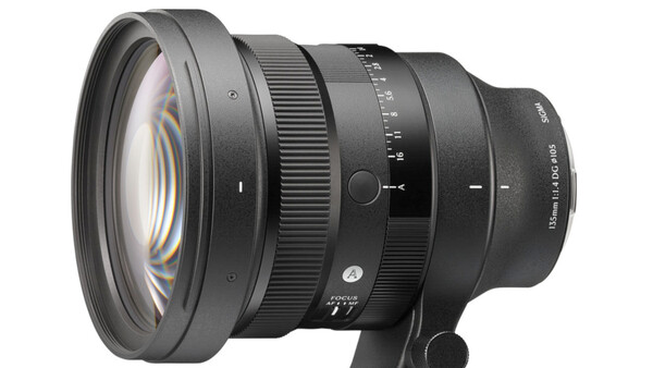 Professional camera lens with optical elements visible through front glass, mounted on a black support base against white background.