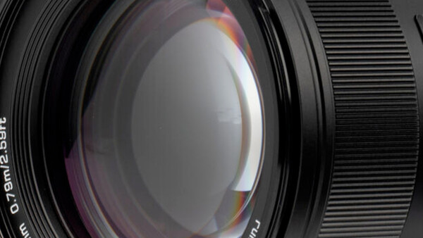 Close-up view of a camera lens showing internal glass elements and optical construction.