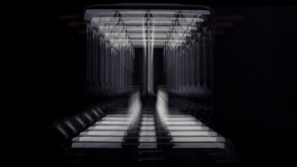 Symmetrical corridor with rows of vertical elements converging toward a vanishing point, lit with dramatic side-lighting creating strong linear shadows.