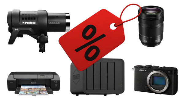 Photography equipment and accessories arranged around a red discount tag, including a studio light, camera lens, external hard drive, printer, and mirrorless camera body.