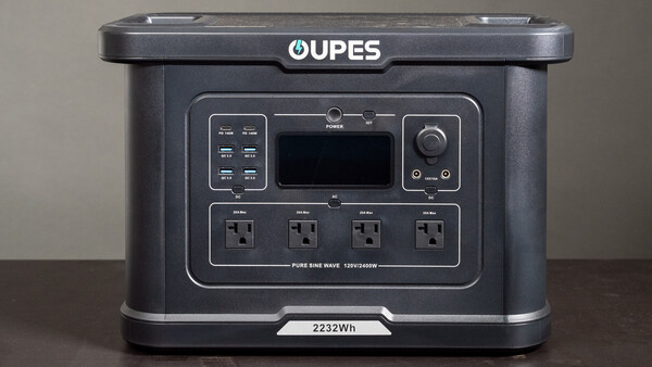 OUPES portable power station with 2232Wh capacity and four AC outlets displayed on brown surface.