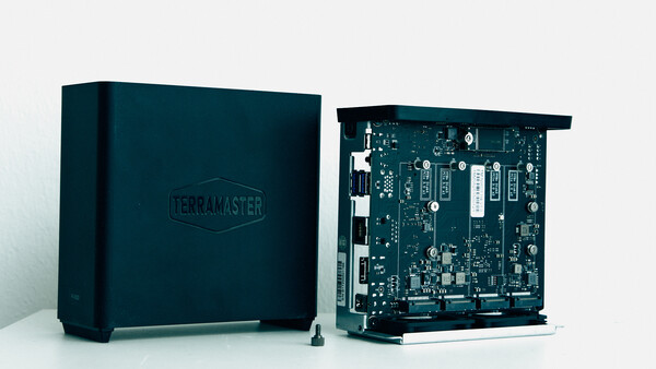 TerraMaster NAS device shown closed and with internal circuit board exposed.