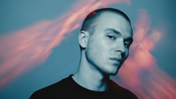 Male portrait against gradient sky with pink clouds during golden hour.