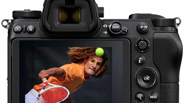 Nikon mirrorless camera with rear LCD screen displaying food photography of a person with produce.