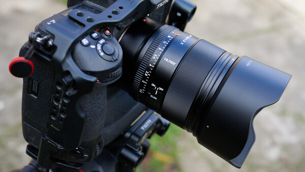Professional cinema camera with attached zoom lens and wireless focus control mounted on a rig.