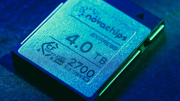 Close-up of a computer processor chip with visible text and specifications under blue-tinted lighting.