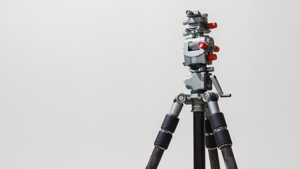 Professional video camera rig mounted on tripod with follow focus system and wireless monitor.