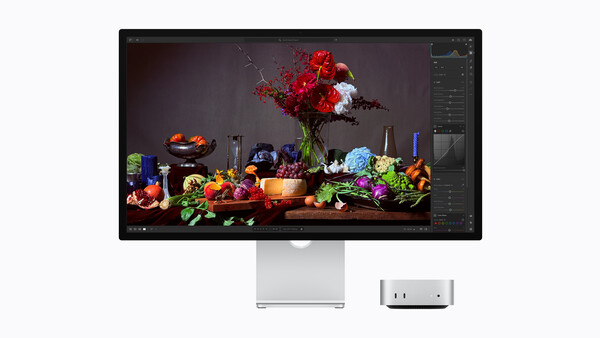 Screenshot of color-grading software displaying a vibrant still life of flowers, produce, and glassware on a dark surface.