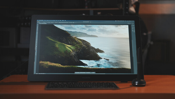 Screenshot of photo editing software displaying a coastal landscape image with green cliffs and calm blue water.