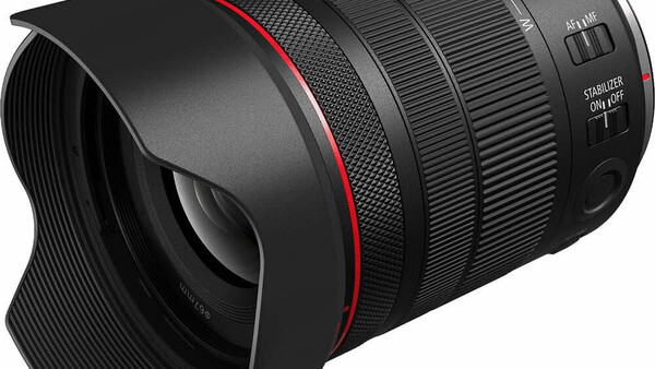 Canon RF-mount telephoto zoom lens with hood and red accent ring