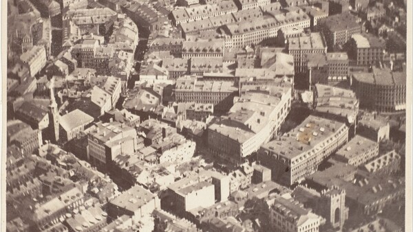 Aerial photograph of dense urban cityscape with tightly packed buildings and street grid