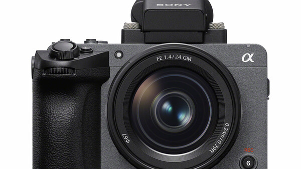 Sony α mirrorless camera with 28mm lens and pop-up flash against white background