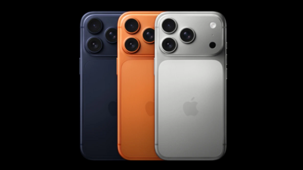 Three smartphones in dark blue, orange, and silver displaying triple rear camera systems with large sensor housings