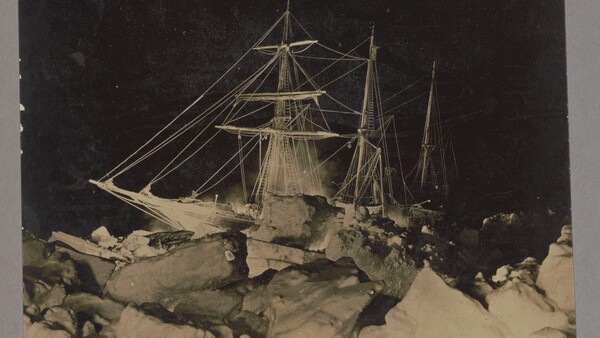 Sailing ship trapped in pack ice under starry night sky
