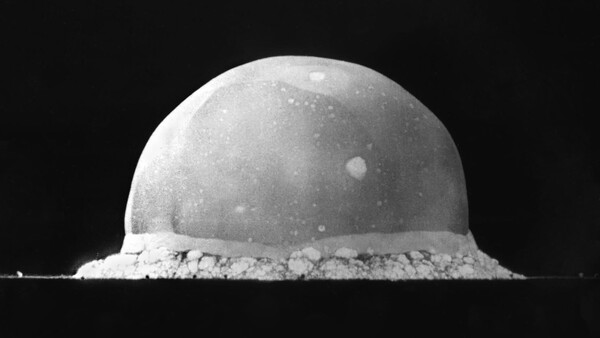 Monochrome photograph of a spherical dome-shaped object with granular base material against black background