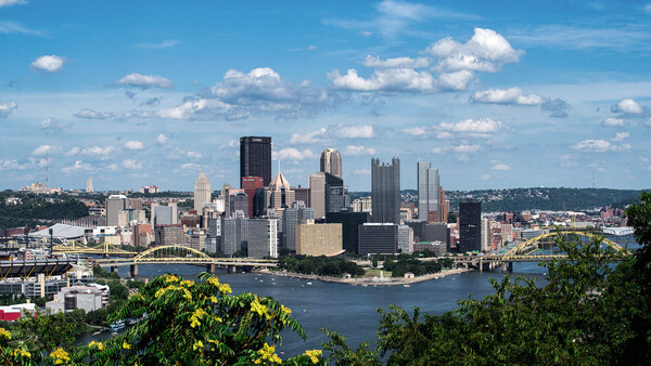Pittsburgh skyline with Golden Triangle downtown district reflected in river, viewed from elevated vantage point