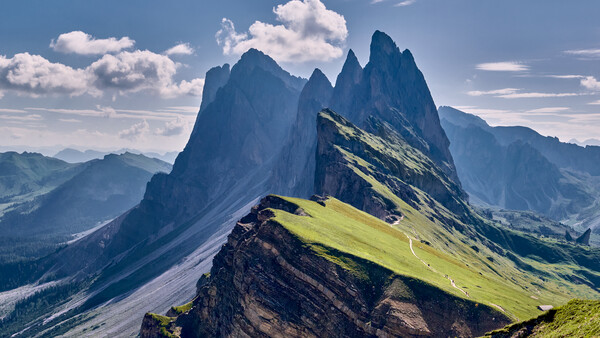 Säntis mountain peak with dramatic vertical rock formations and green alpine meadows in Swiss Alps