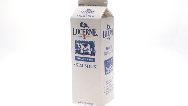 Lucerne skim milk carton with blue cow logo on white background