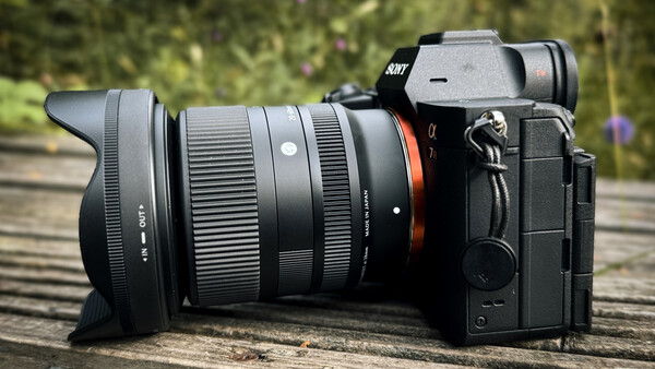 Sony mirrorless camera with wide-angle lens on wooden surface outdoors
