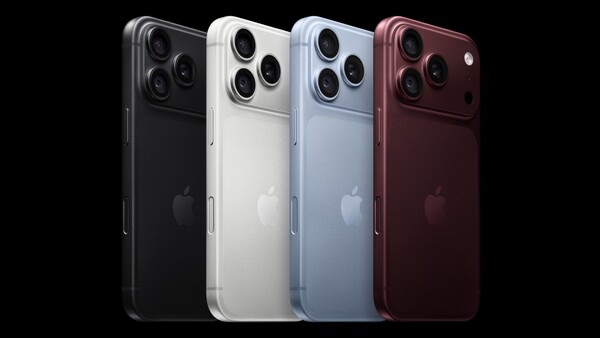 Four Apple iPhones displayed in black, white, light blue, and deep red finishes against a black background