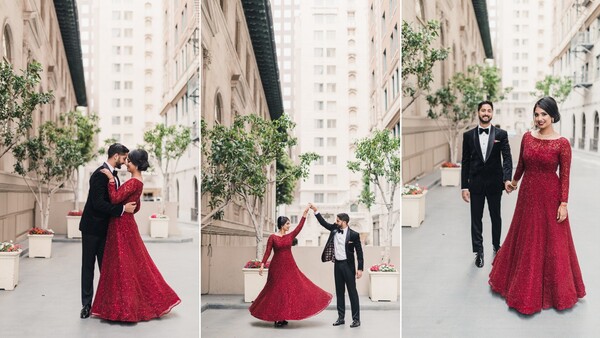 Couple in formal attire dancing and posing in urban courtyard with modern buildings