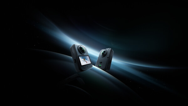 Two compact action cameras positioned facing each other against a dramatic dark background with glowing blue light rays