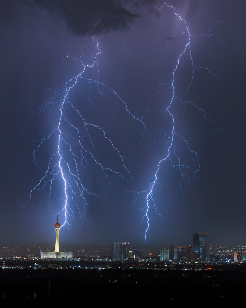 Two lightning bolts striking near the U.S. Capitol building during a nighttime thunderstorm