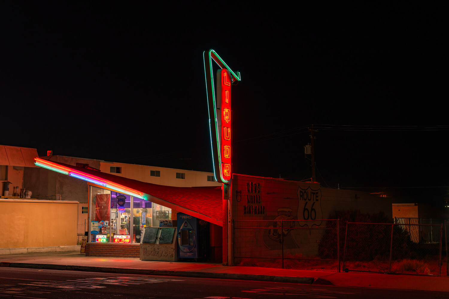 Vintage neon-lit diner at night with glowing red vertical sign and storefront