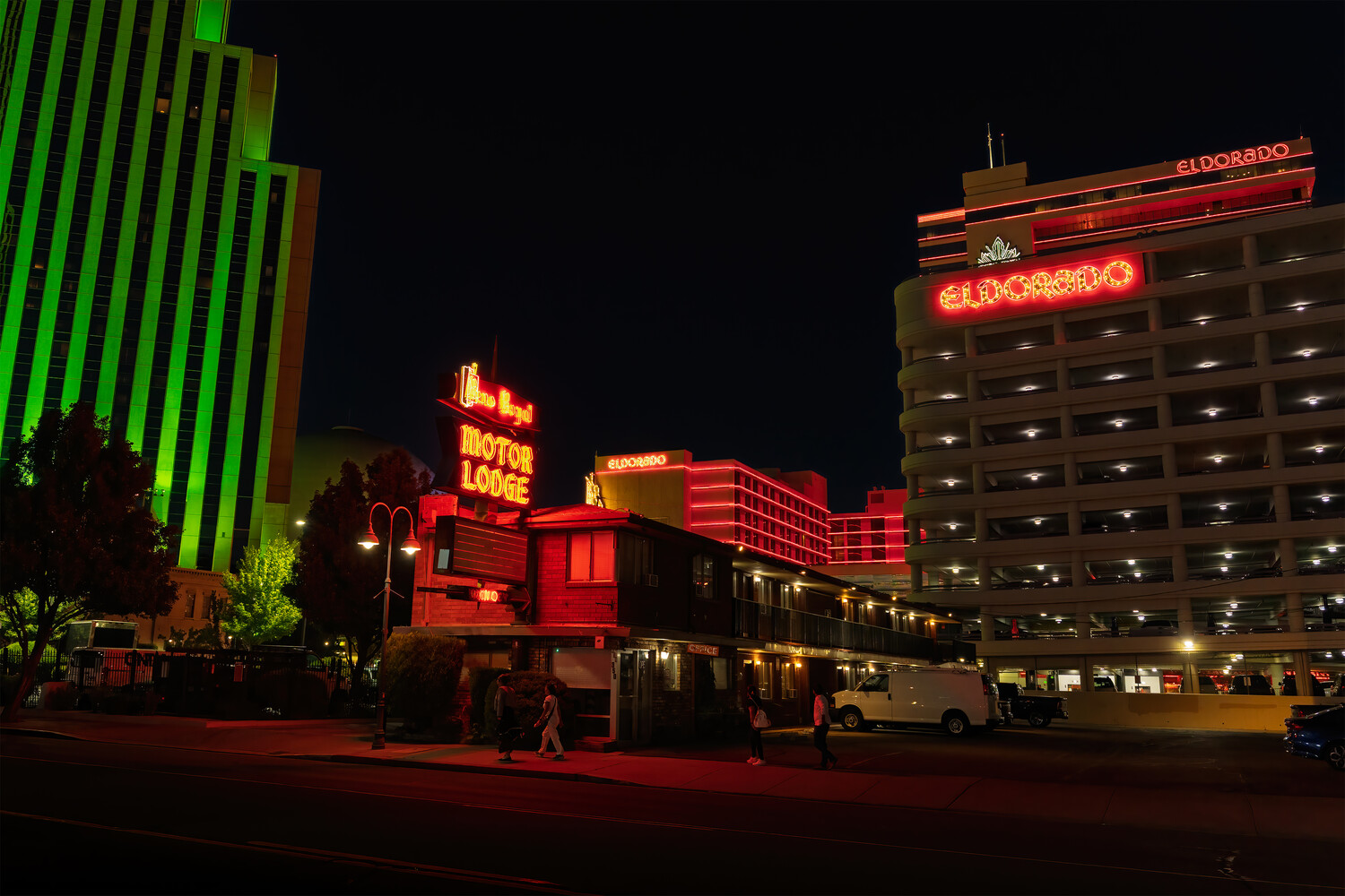 Neon-lit vintage train and casino buildings illuminated at night