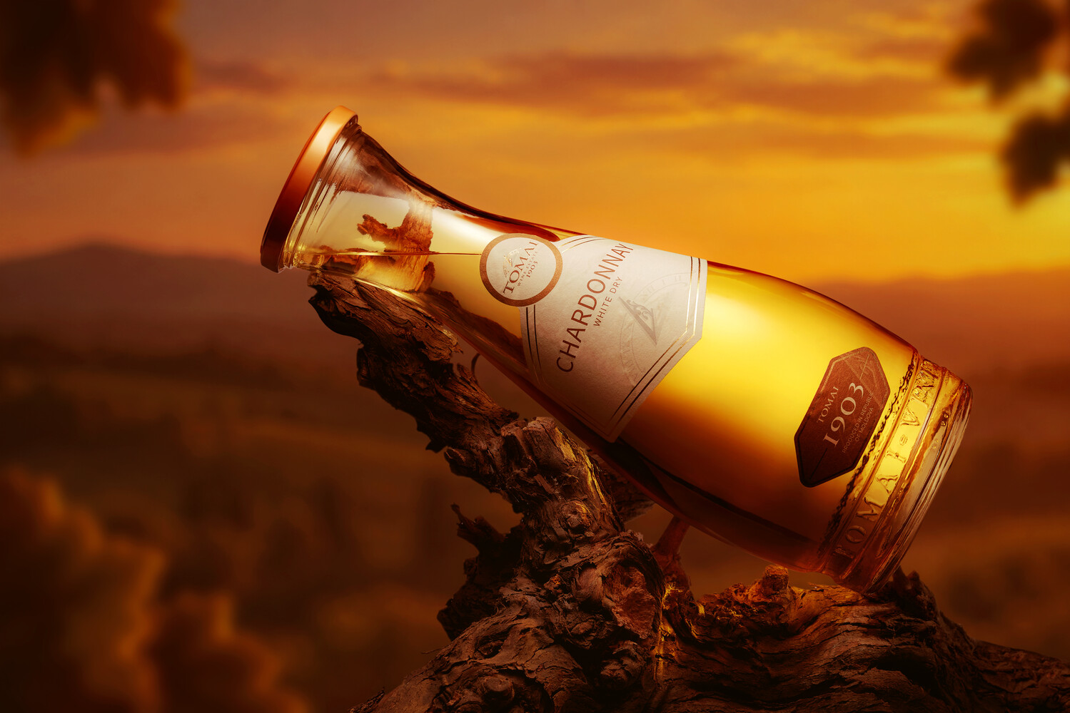 Luxury alcohol bottle tilted on textured wood against golden sunset sky