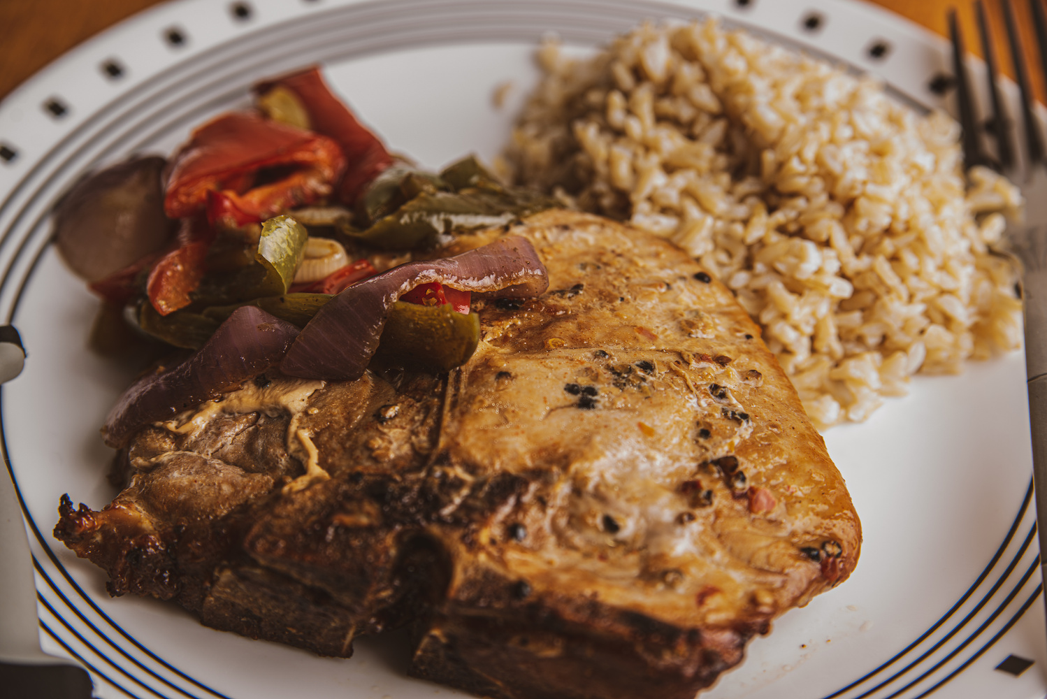 View Pork Chop with Brown Rice, and Peppers & Onions by Gary Brosius