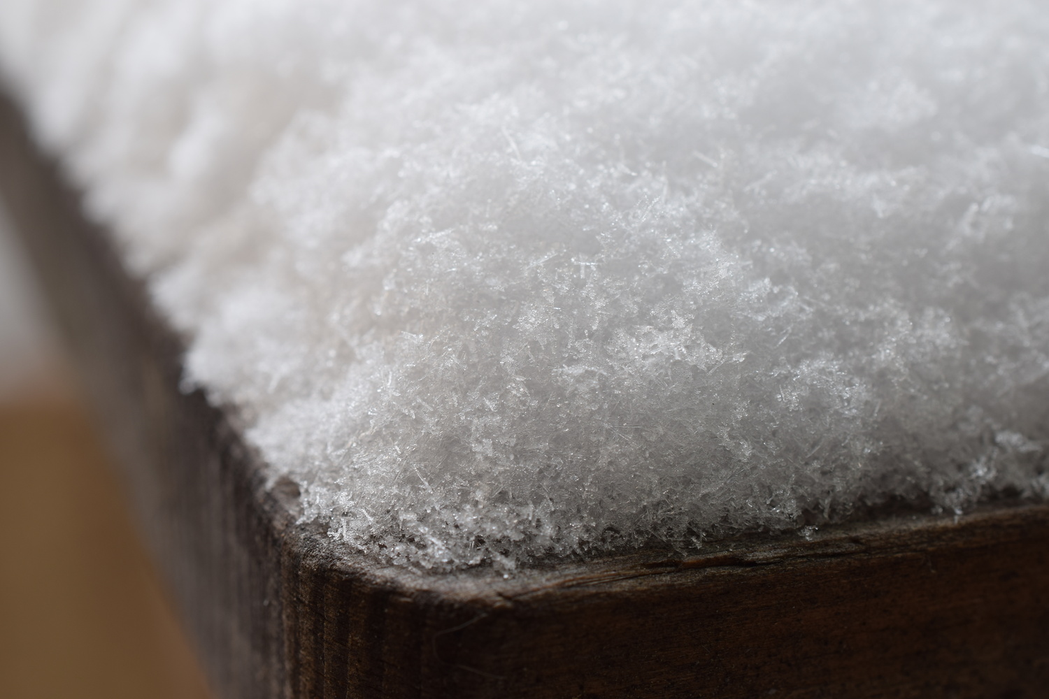 View Snow on wooden bench by Romain Gehrig