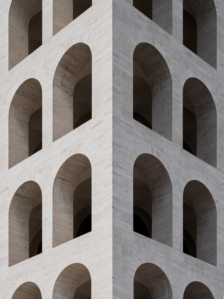 Modernist building facade with repeating arched window openings in concrete