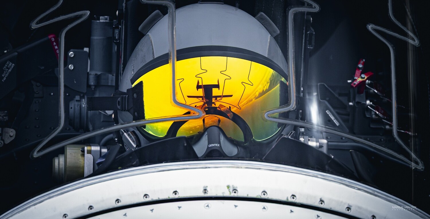 Overhead view of a spacecraft heat shield with yellow-glowing interior and equipment mounted symmetrically
